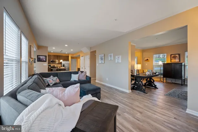 a kitchen with stainless steel appliances kitchen island granite countertop a refrigerator and cabinets