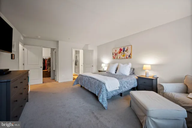 a bathroom with a granite countertop sink toilet and a mirror