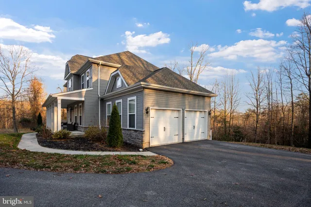 a front view of a house with a yard and lake view