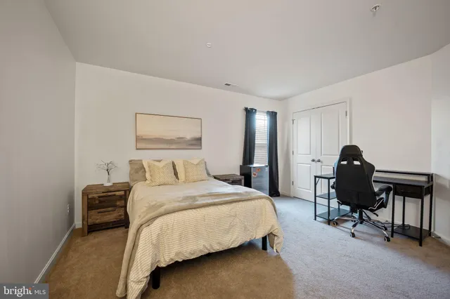 a view of a livingroom with workspace and a couch