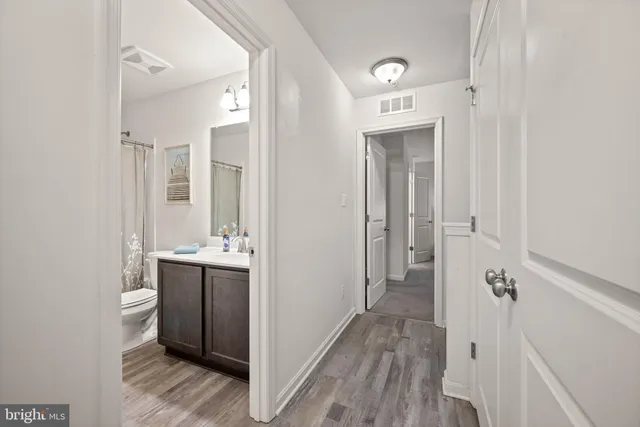 a view of a large house with a big yard and large trees