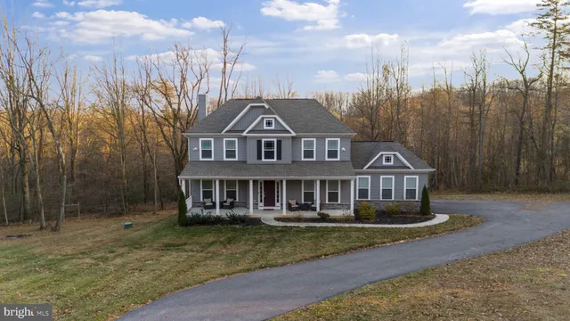 an aerial view of a house with outdoor space and a lake view