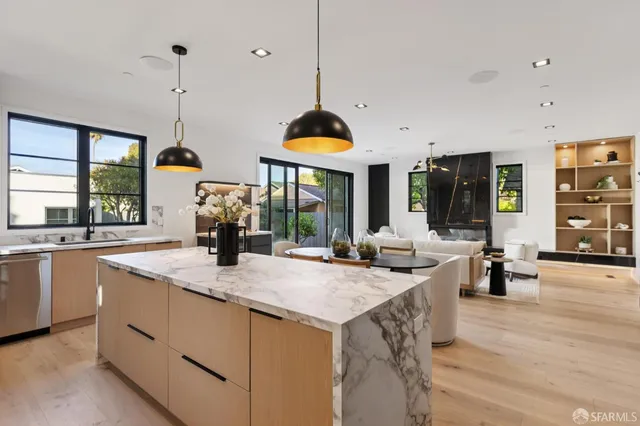 a kitchen with stainless steel appliances granite countertop a sink and a table