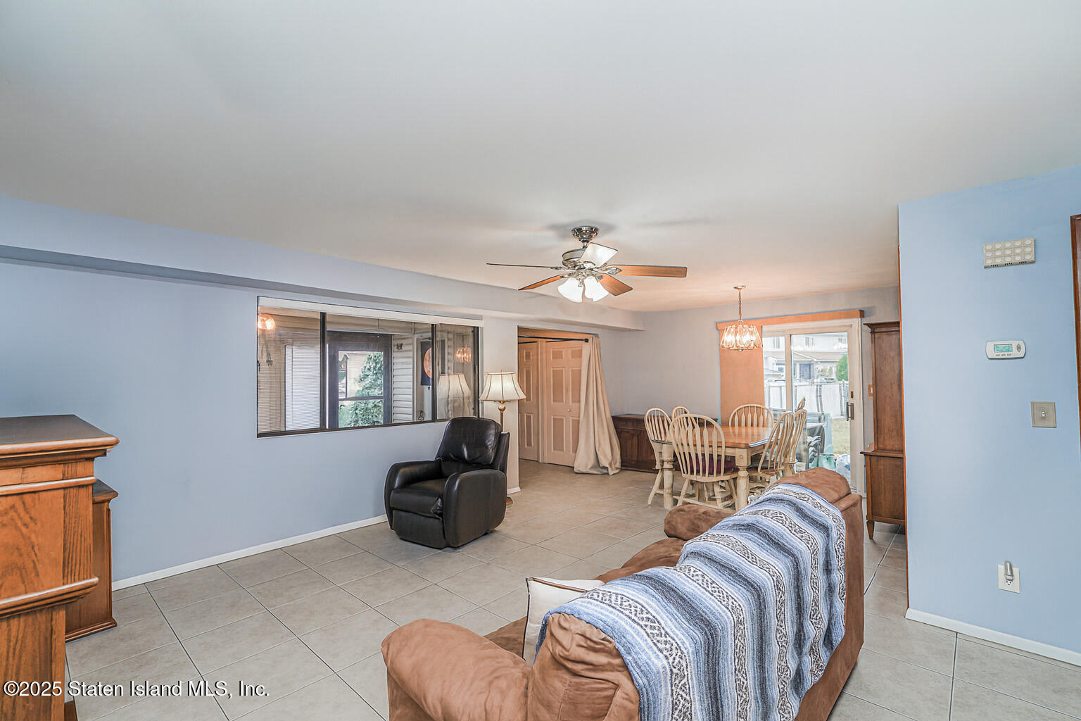 22 Regis Drive Staten Island, NY 10314 - Photo 12 of 22 a living room with furniture a fireplace and a flat screen tv