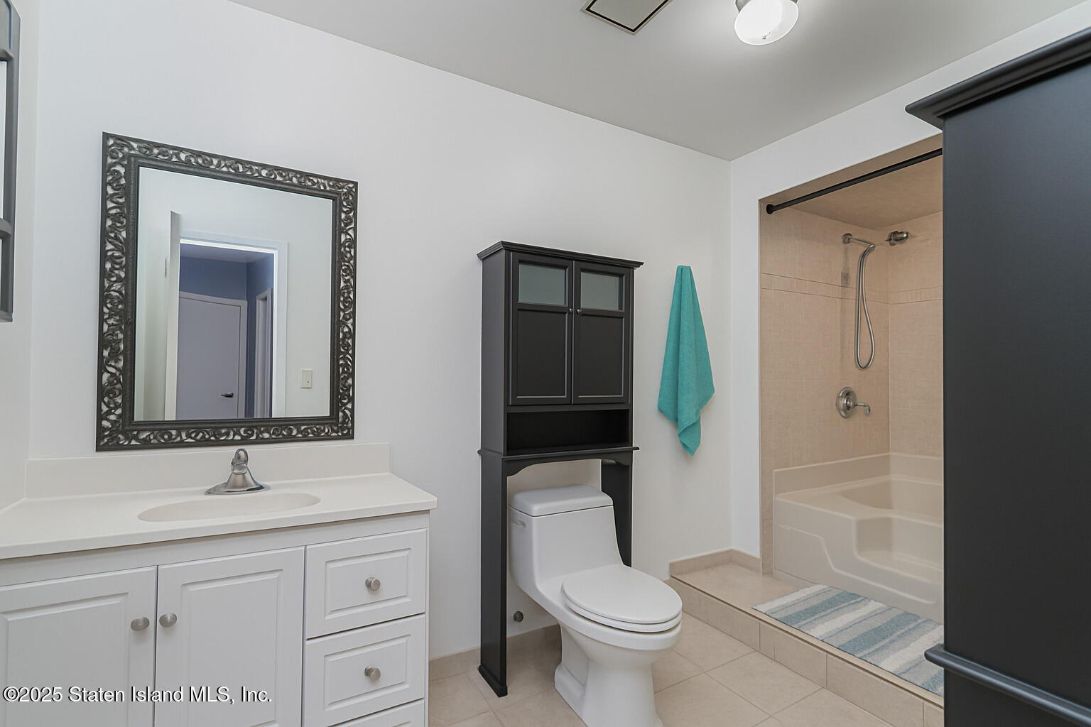 22 Regis Drive Staten Island, NY 10314 - Photo 14 of 22 a bathroom with a toilet a sink and mirror