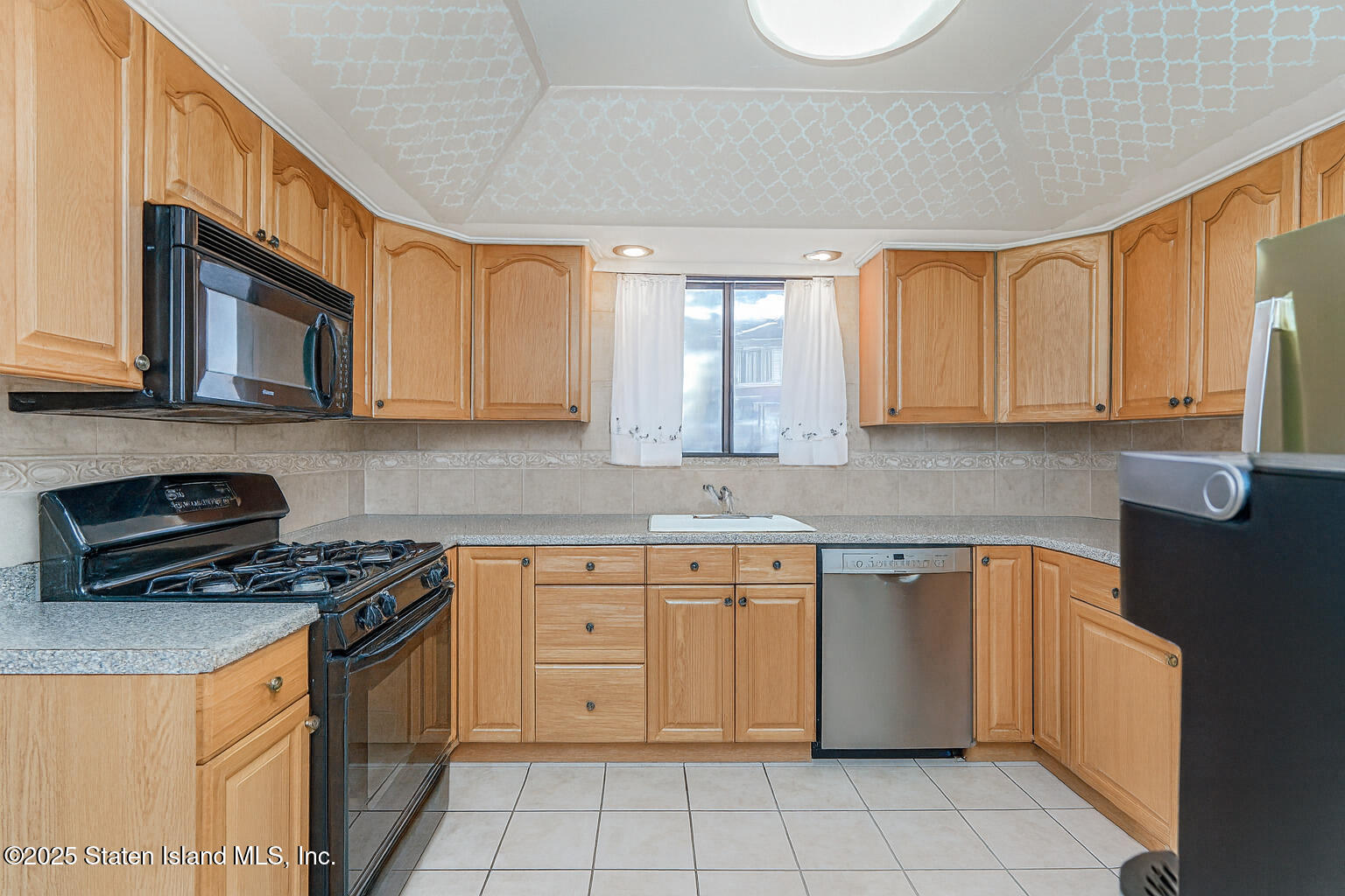 22 Regis Drive Staten Island, NY 10314 - Photo 5 of 22 a kitchen with stainless steel appliances granite countertop a stove a sink dishwasher and a microwave oven on the blue kitchen countertops