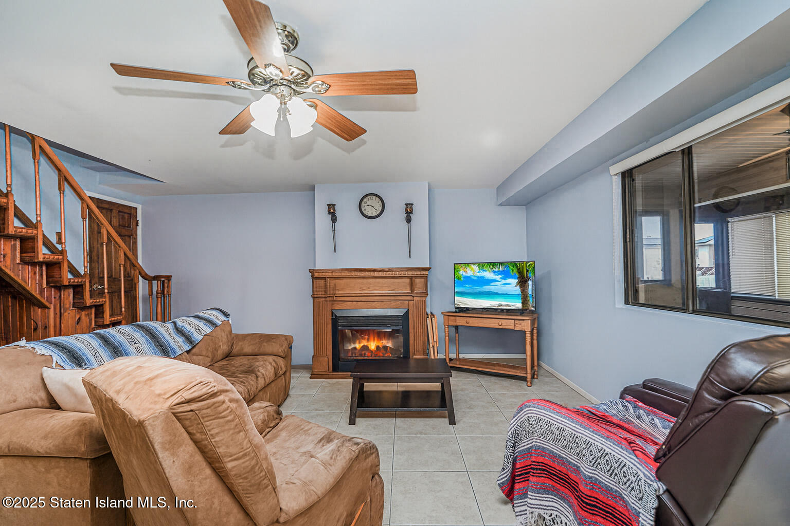 22 Regis Drive Staten Island, NY 10314 - Photo 10 of 22 a living room with furniture and a fireplace