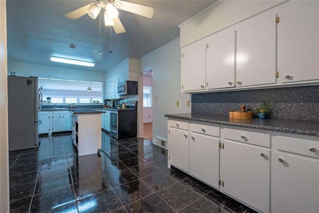 112 College Circle Cedartown, GA 30125 - Photo 11 of 35 a kitchen with stainless steel appliances granite countertop a refrigerator a stove a sink and white cabinets