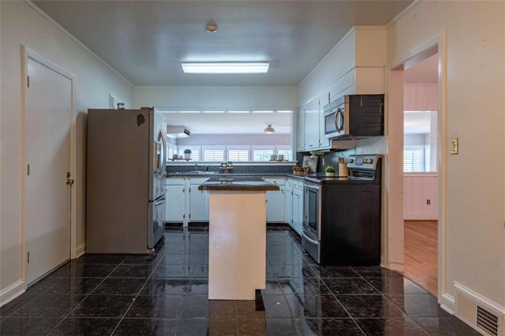 112 College Circle Cedartown, GA 30125 - Photo 12 of 35 a kitchen with stainless steel appliances granite countertop a refrigerator a stove a sink and a microwave