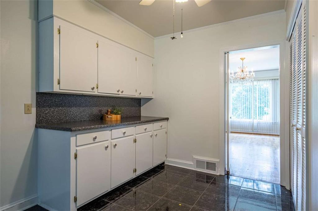 112 College Circle Cedartown, GA 30125 - Photo 15 of 35 a kitchen with granite countertop white cabinets and sink