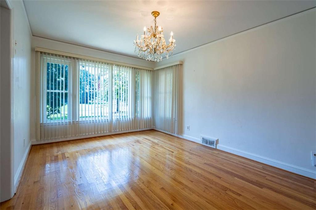 112 College Circle Cedartown, GA 30125 - Photo 26 of 35 a view of an empty room with wooden floor and a window