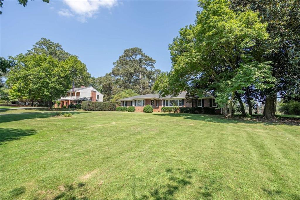 112 College Circle Cedartown, GA 30125 - Photo 3 of 35 a front view of a house with a garden