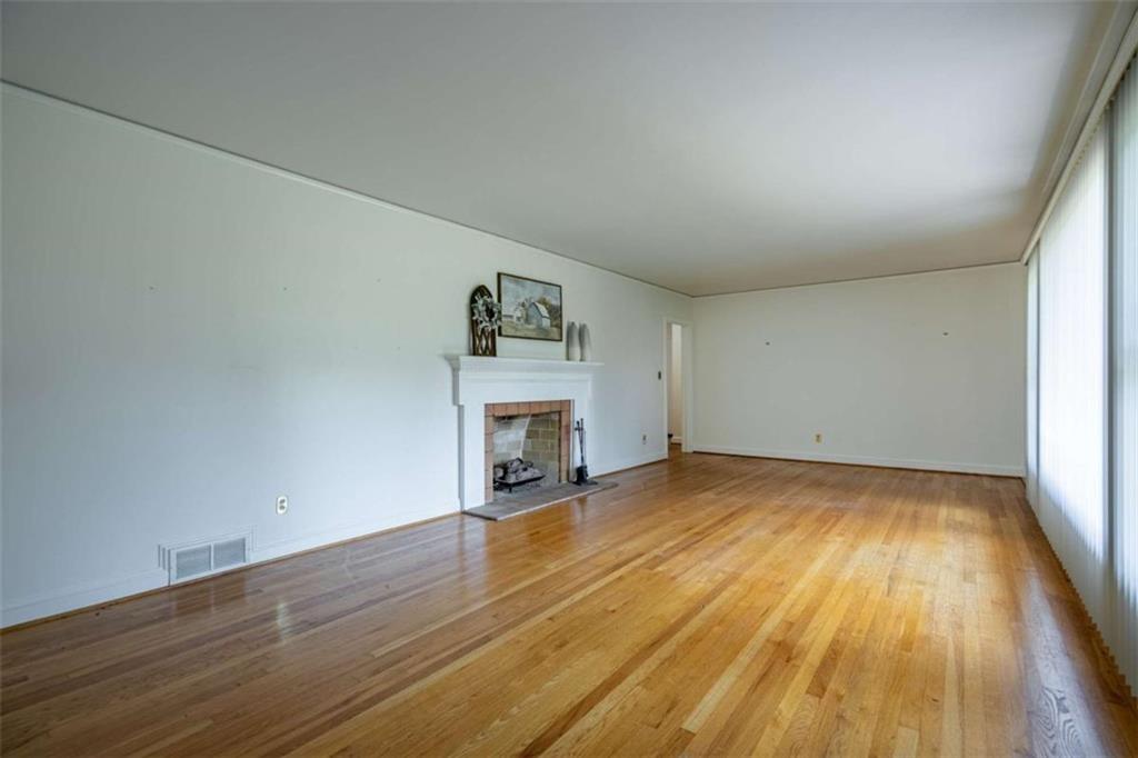 112 College Circle Cedartown, GA 30125 - Photo 6 of 35 a view of empty room with wooden floor and fireplace