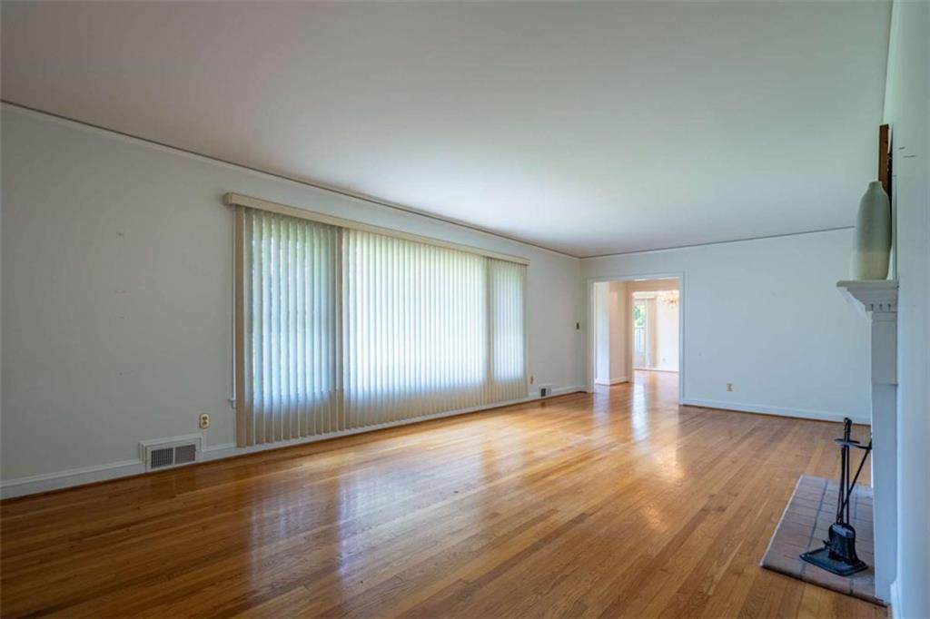 112 College Circle Cedartown, GA 30125 - Photo 7 of 35 an empty room with wooden floor and windows