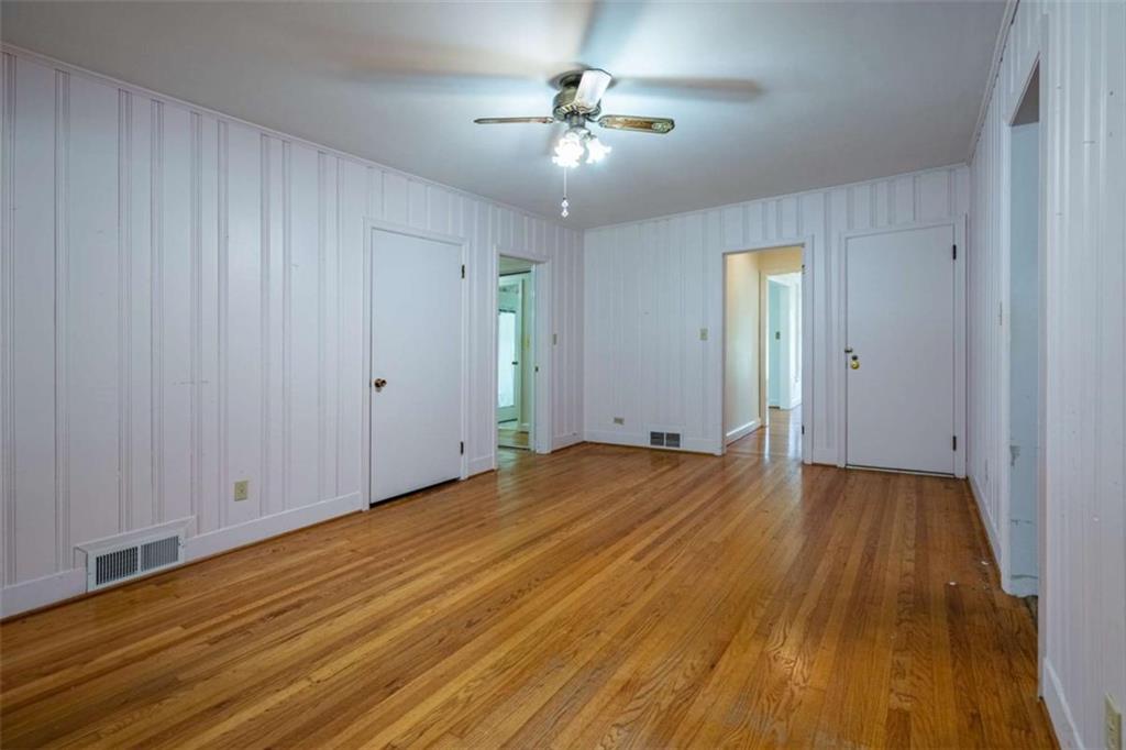 112 College Circle Cedartown, GA 30125 - Photo 9 of 35 an empty room with wooden floor and a ceiling fan