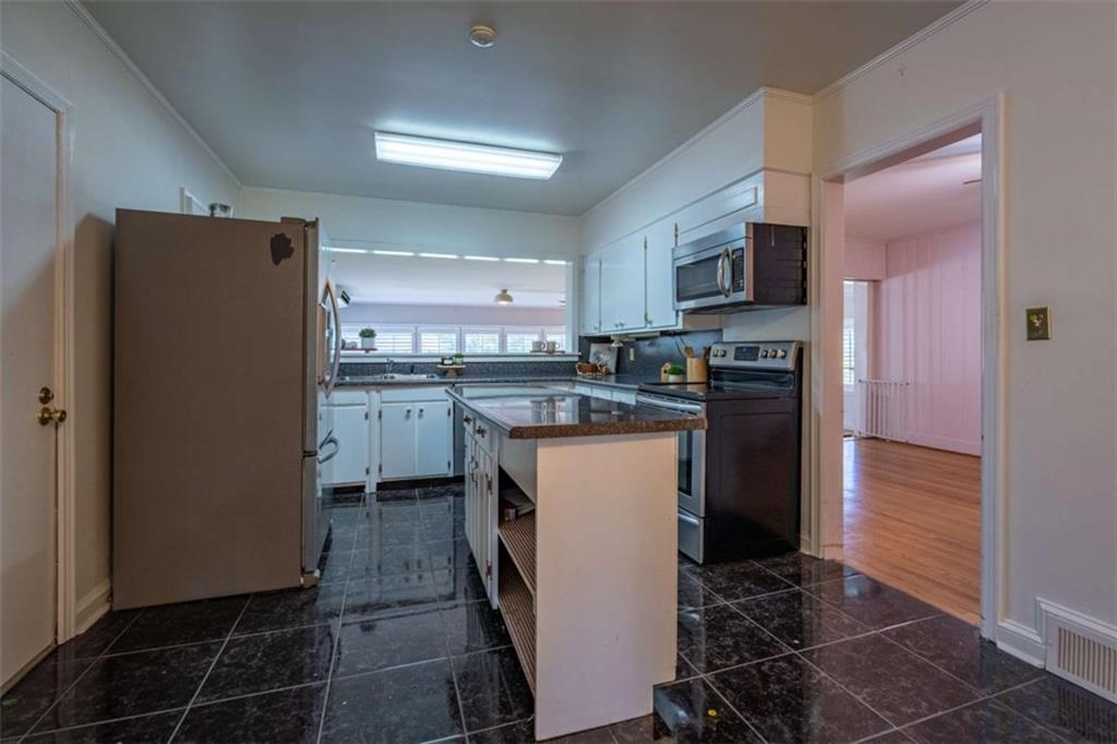 112 College Circle Cedartown, GA 30125 - Photo 10 of 35 a kitchen with stainless steel appliances granite countertop a refrigerator a stove a sink a microwave and island