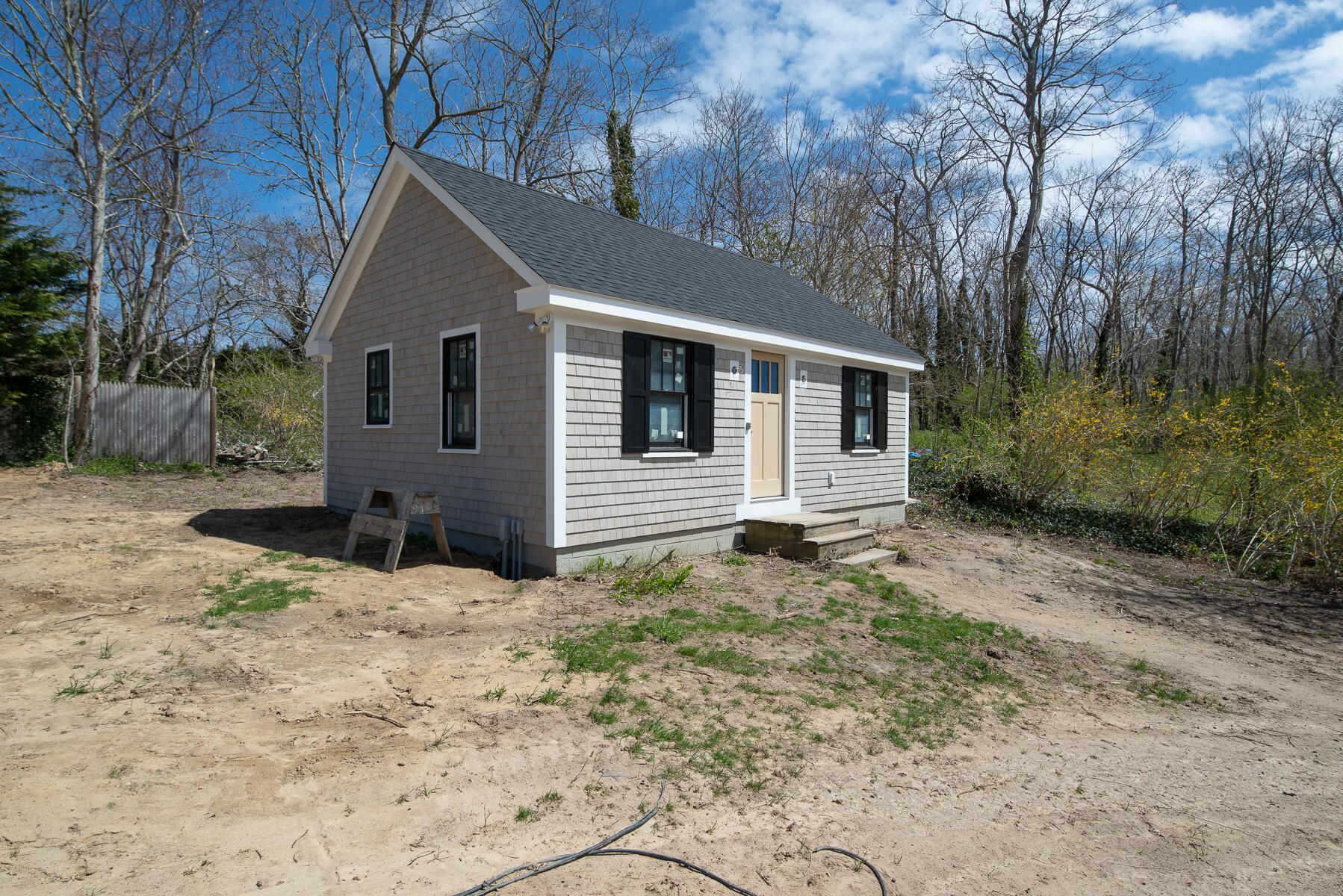 86 West Road Orleans, MA 02653 - Photo 7 of 16 a house with trees in the background