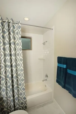 a bathroom with a bathtub and shower