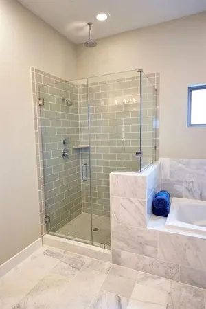 a bathroom with a tub shower and checkered floor