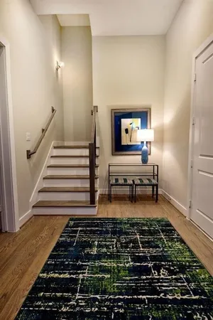a living room with furniture and a rug