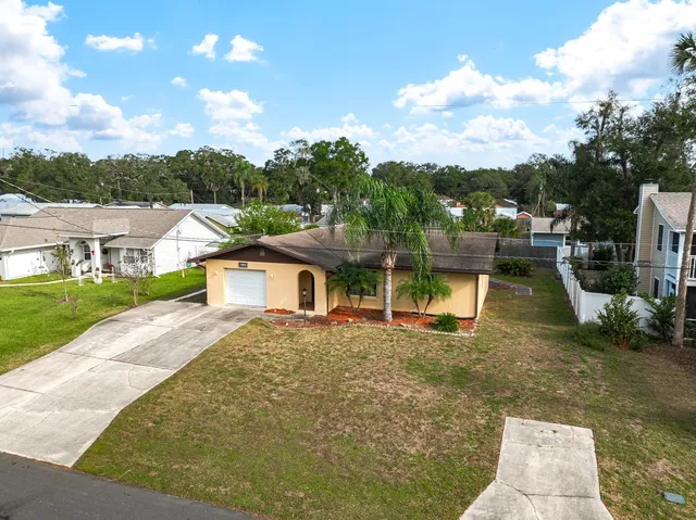 a view of a house with backyard porch and sitting area