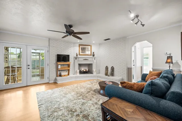 a living room with furniture a fireplace and a flat screen tv