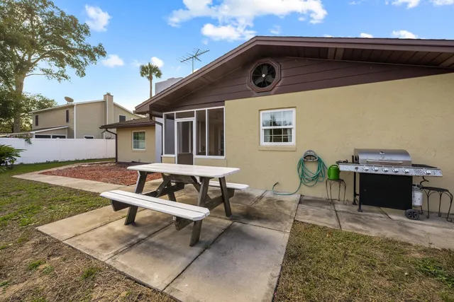 a backyard of a house with outdoor seating