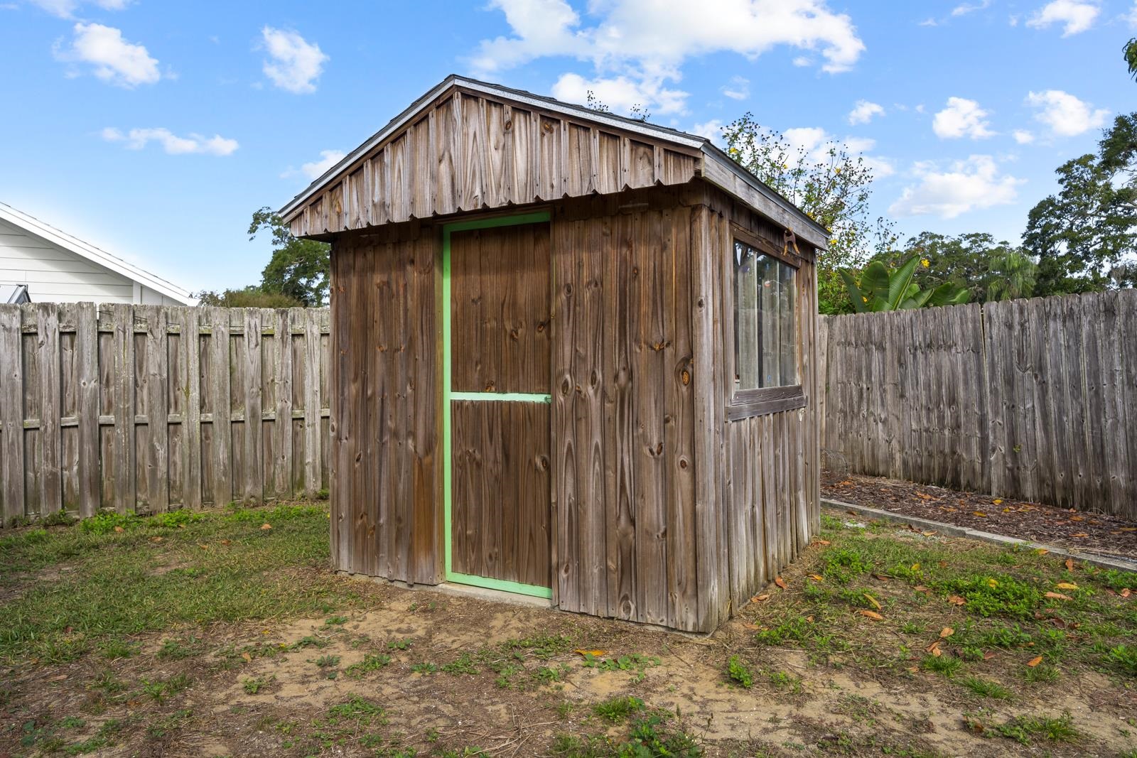 345 Cypress Road St. Augustine, FL 32086 - Photo 32 of 56 a view of a small house with wooden fence