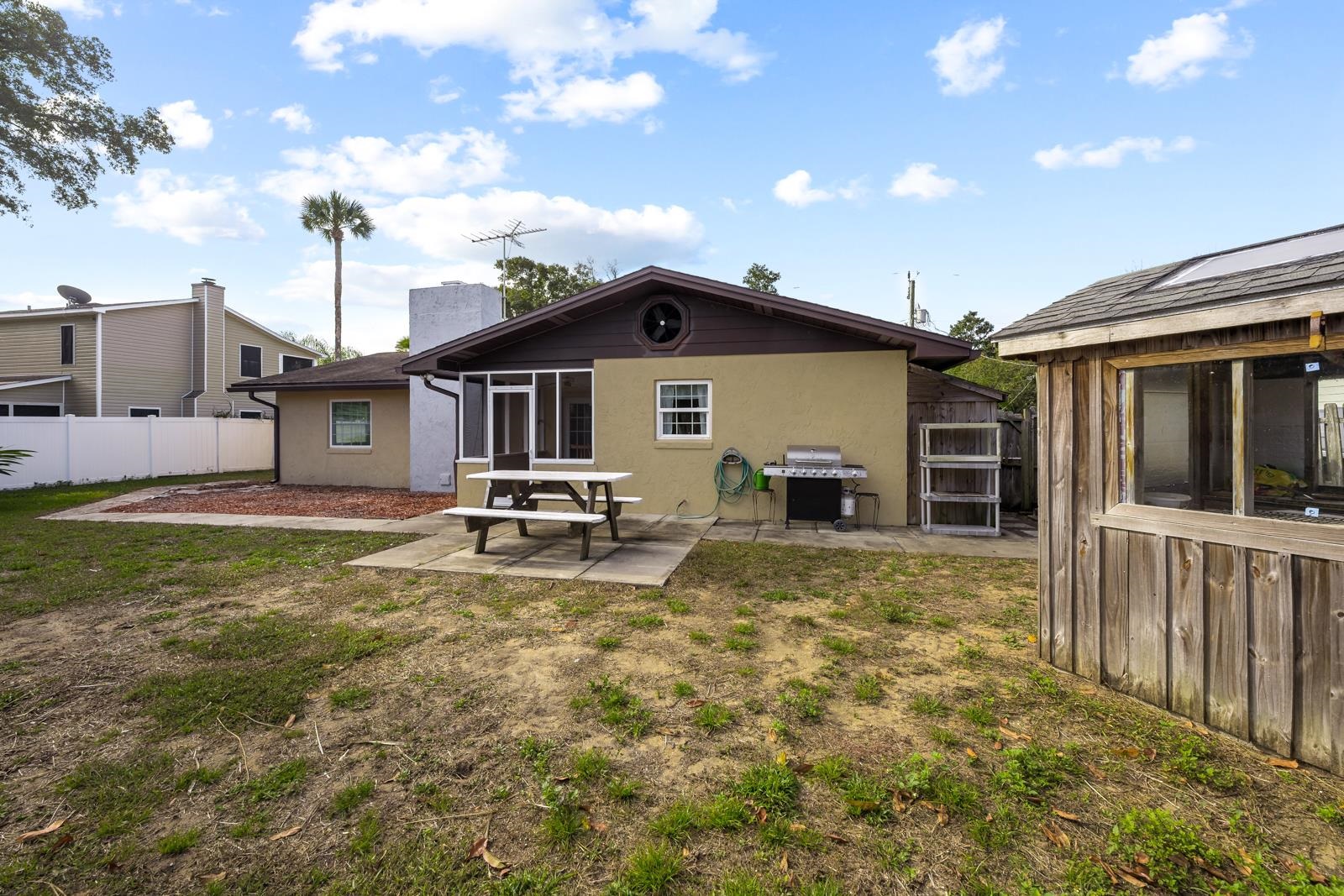 345 Cypress Road St. Augustine, FL 32086 - Photo 34 of 56 Rear view of house with a sunroom, a patio, and stucco siding