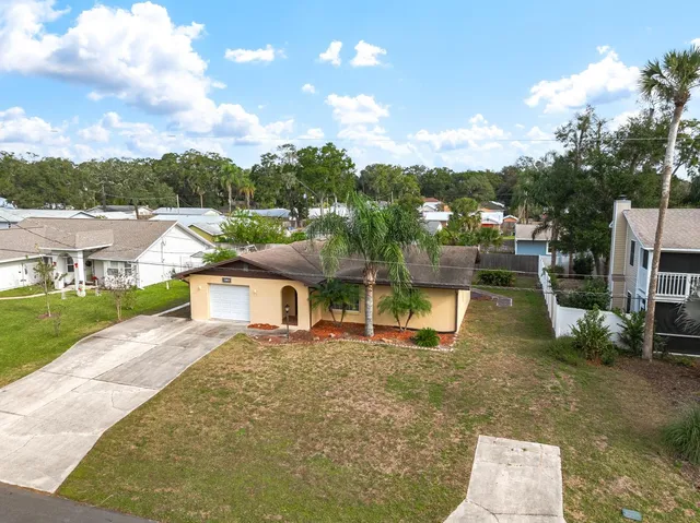 an aerial view of a house with a yard