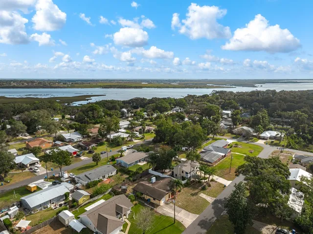 an aerial view of a house with a yard