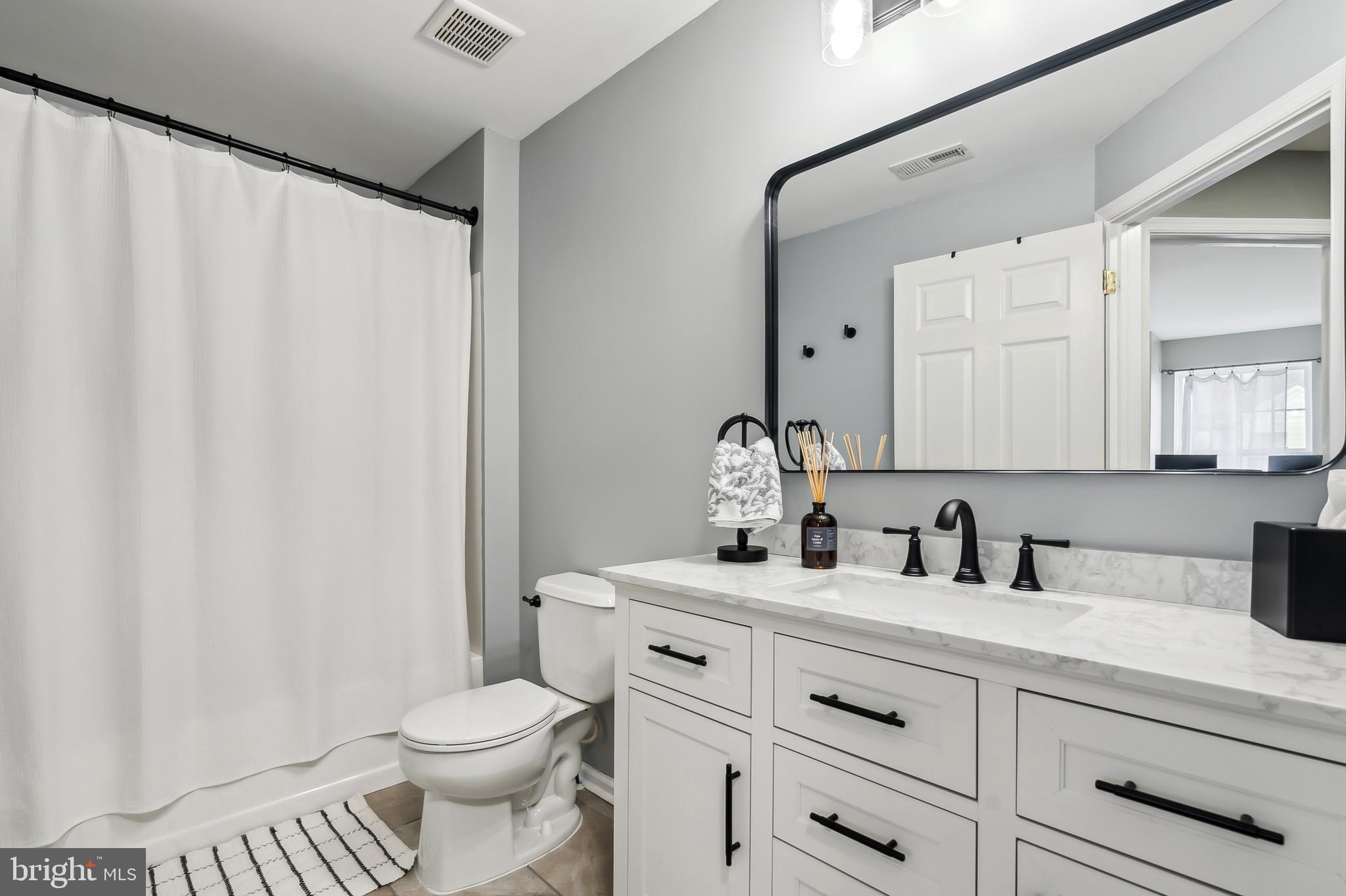 28 Teal Court Riverside, NJ 08075 - Photo 21 of 24 a bathroom with a sink a toilet and a mirror