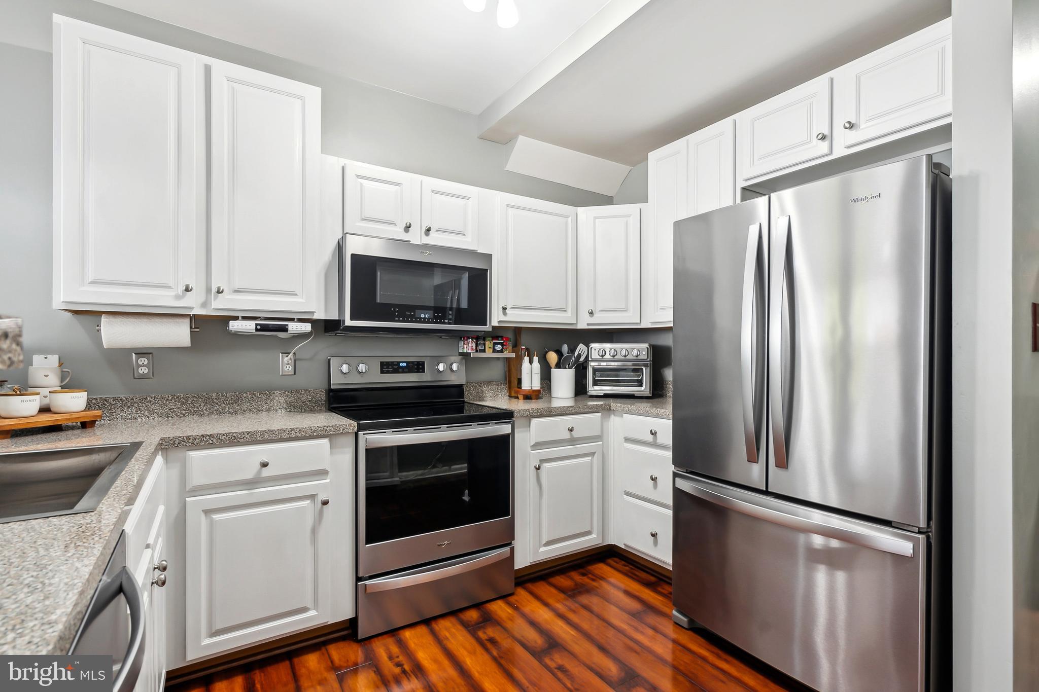 28 Teal Court Riverside, NJ 08075 - Photo 4 of 24 a kitchen with white cabinets and stainless steel appliances