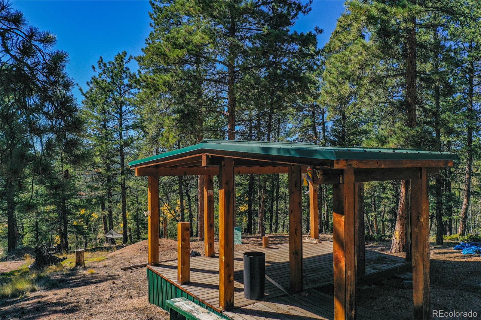 3447 Pathfinder Road Florissant, CO 80816 - Photo 27 of 40 a view of a wooden deck next to a yard