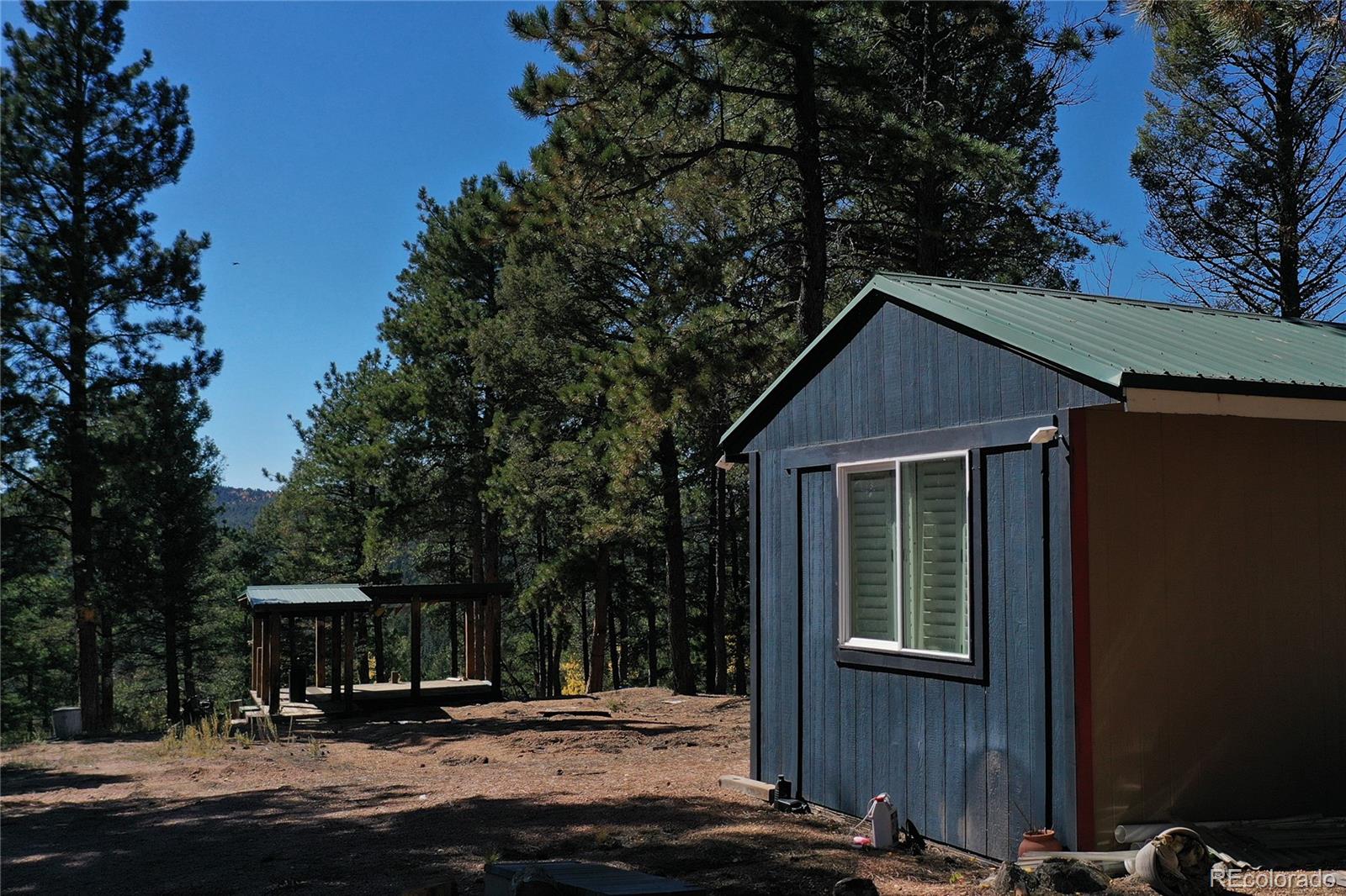 3447 Pathfinder Road Florissant, CO 80816 - Photo 28 of 40 a front view of a house with a yard