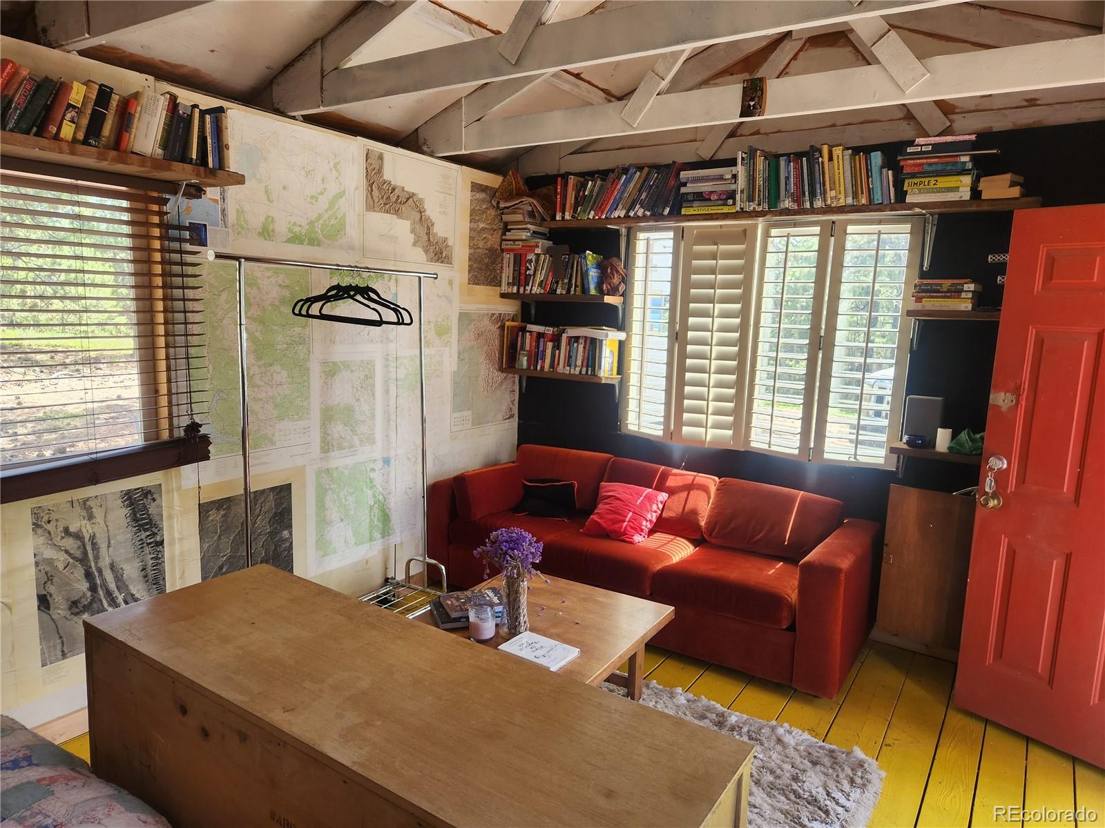 3447 Pathfinder Road Florissant, CO 80816 - Photo 30 of 40 a living room with furniture a flat screen tv and a refrigerator
