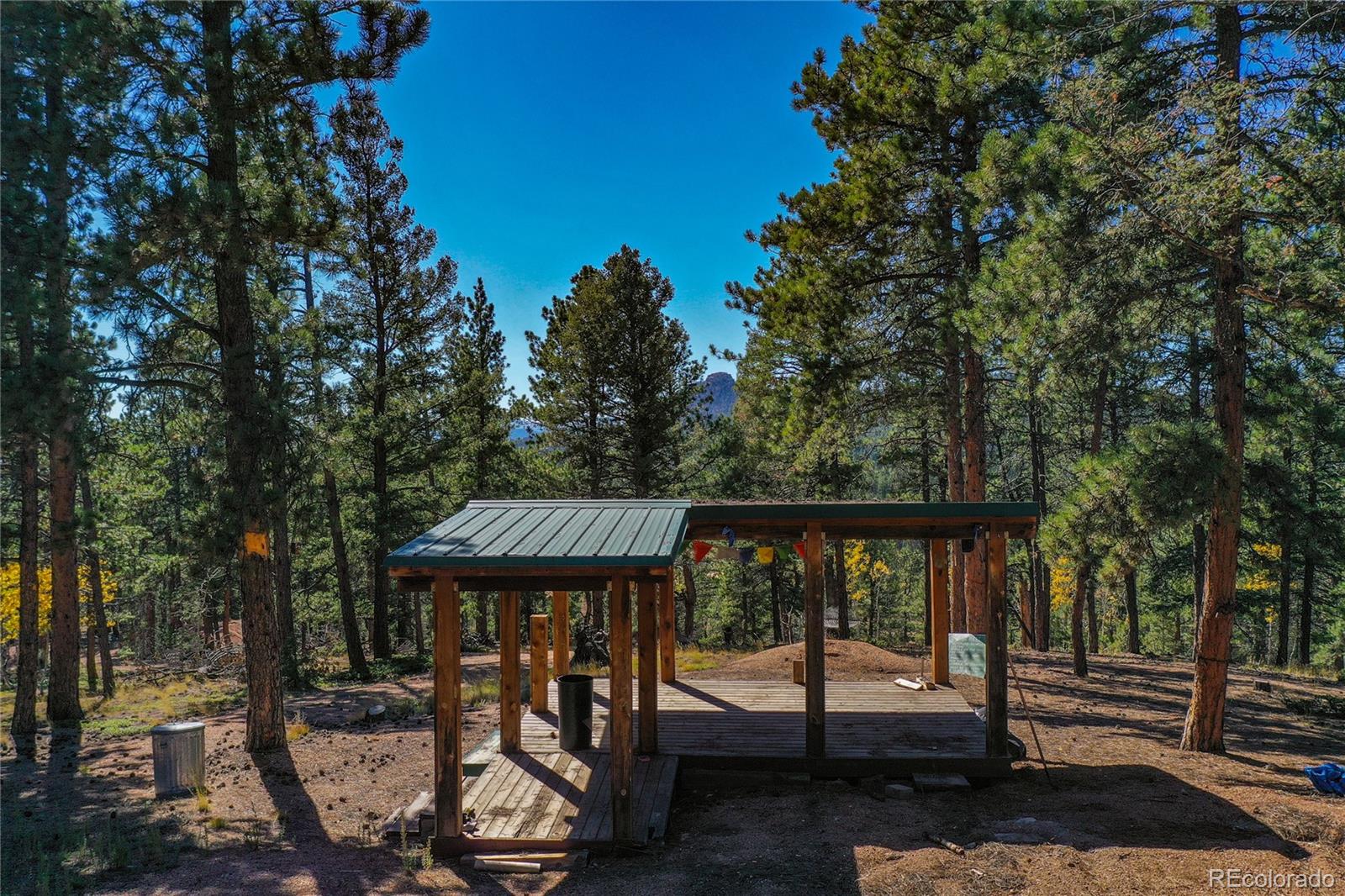 3447 Pathfinder Road Florissant, CO 80816 - Photo 7 of 40 a view of a patio with table and chairs and floor to ceiling window
