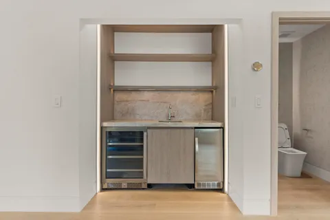 a room with a bench and cabinets