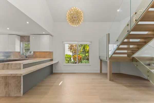 a large white kitchen with a large window