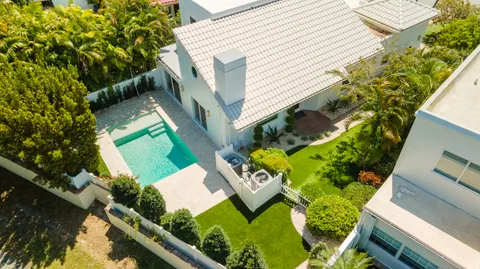 an aerial view of a house with a yard