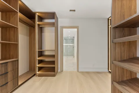 a view of walk in closet with empty racks