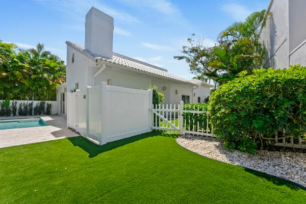 a view of a house with a small yard and plants