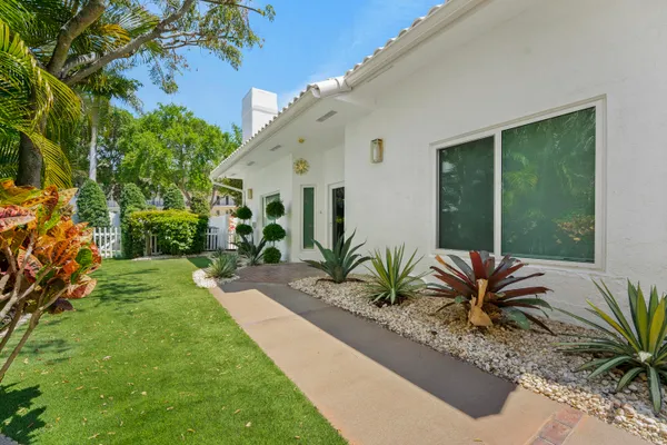 a view of a house with backyard and a patio