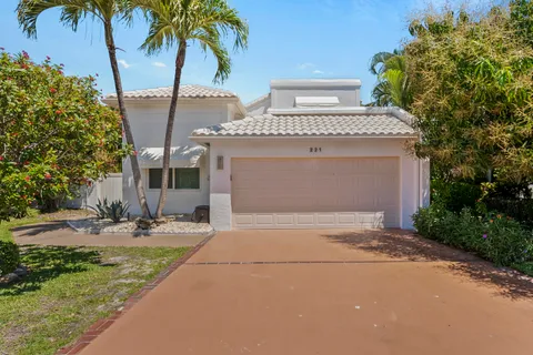 a front view of a house with garden and patio