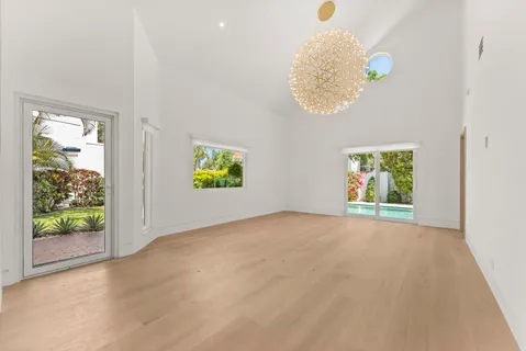 an empty room with windows and entrance