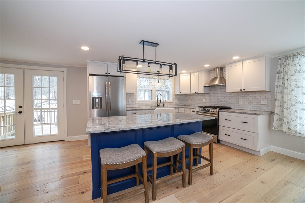 3 Woods Road Westminster, MA 01473 - Photo 2 of 42 a kitchen with granite countertop white cabinets and stainless steel appliances