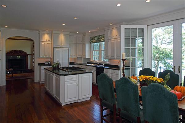 67 Sandy Pond Road Lincoln, MA 01773 - Photo 6 of 21 a kitchen with stainless steel appliances granite countertop a stove a sink dishwasher and a dining table with wooden floor