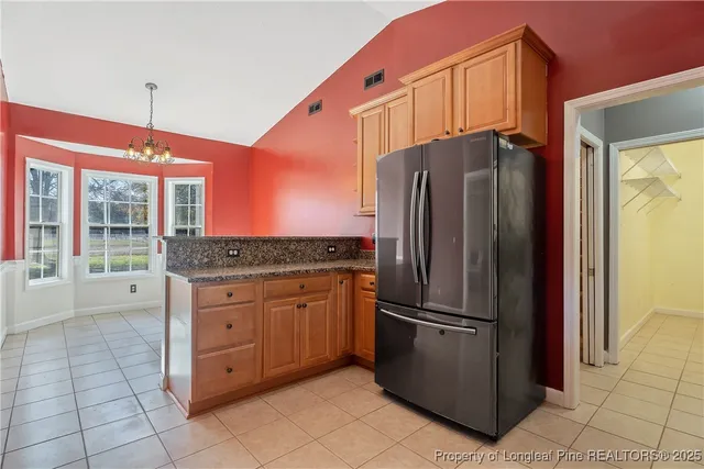 a kitchen with stainless steel appliances granite countertop a refrigerator and a sink