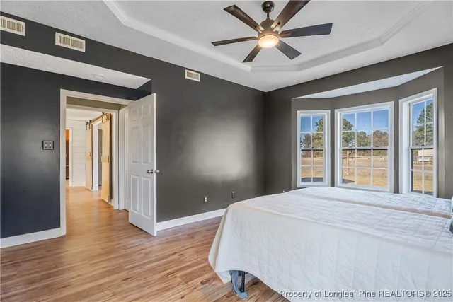 a bedroom with a bed and a large window