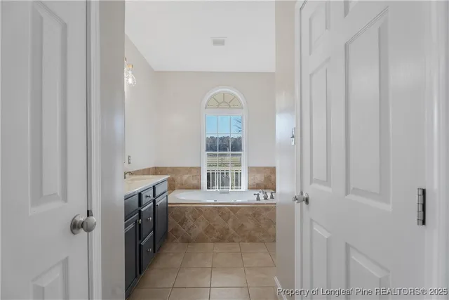 a bathroom with a bathtub and shower
